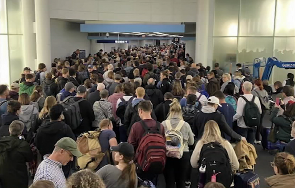 Hundreds of inbound passengers wait in a coronavirus screening line at Chicago's O'Hare International Airport