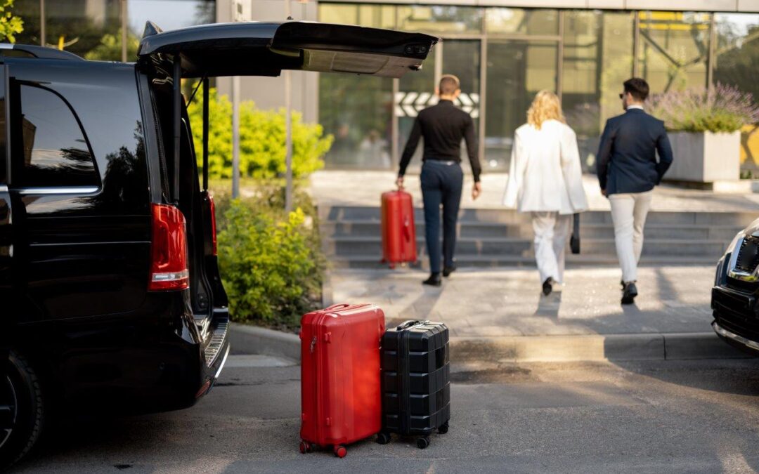 Driver helps a business couple carry their suitcases to the hotel